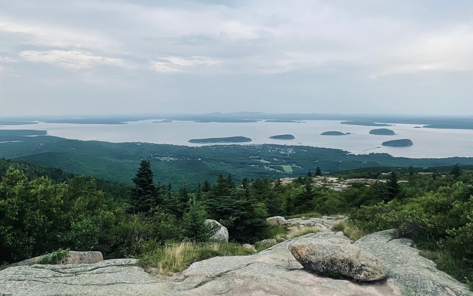Pink granite summit of Cadillac Mountain at dawn with Frenchman Bay and the Porcupine Islands visible below, Acadia National Park, Maine